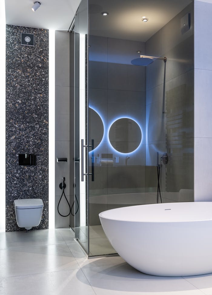 Interior of modern spacious bathroom with bright lamps