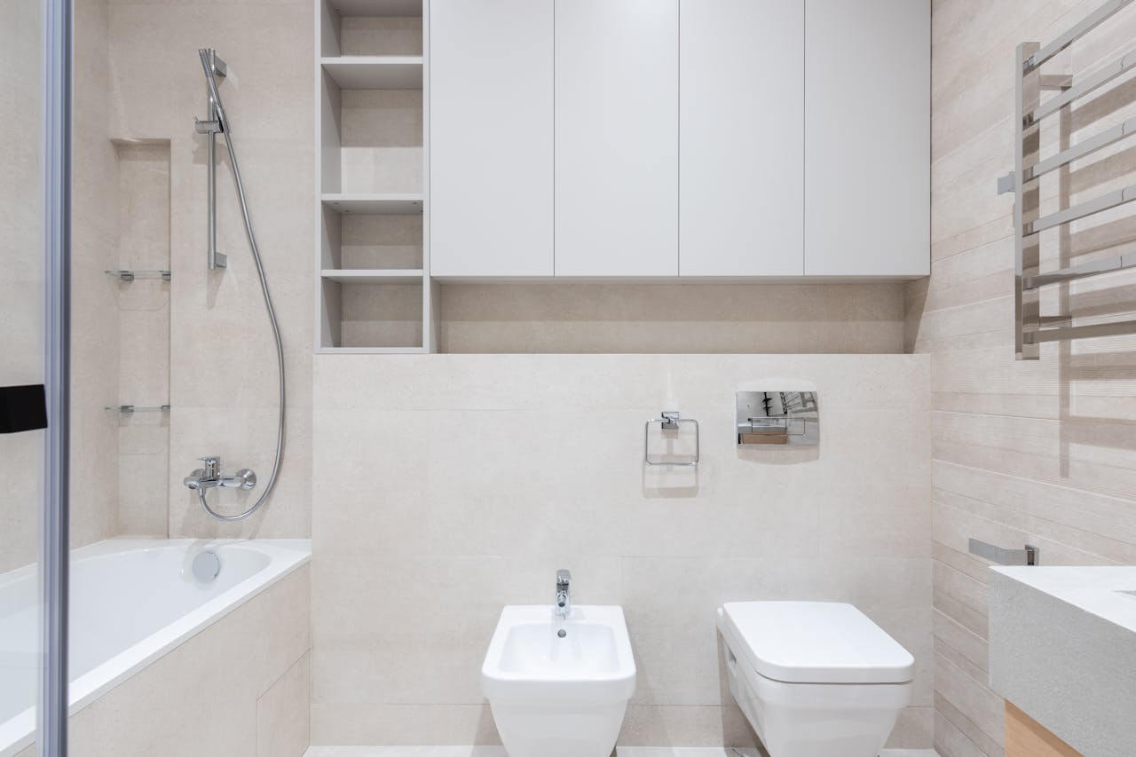 Bathroom with toilet and bidet near bathtub and sink