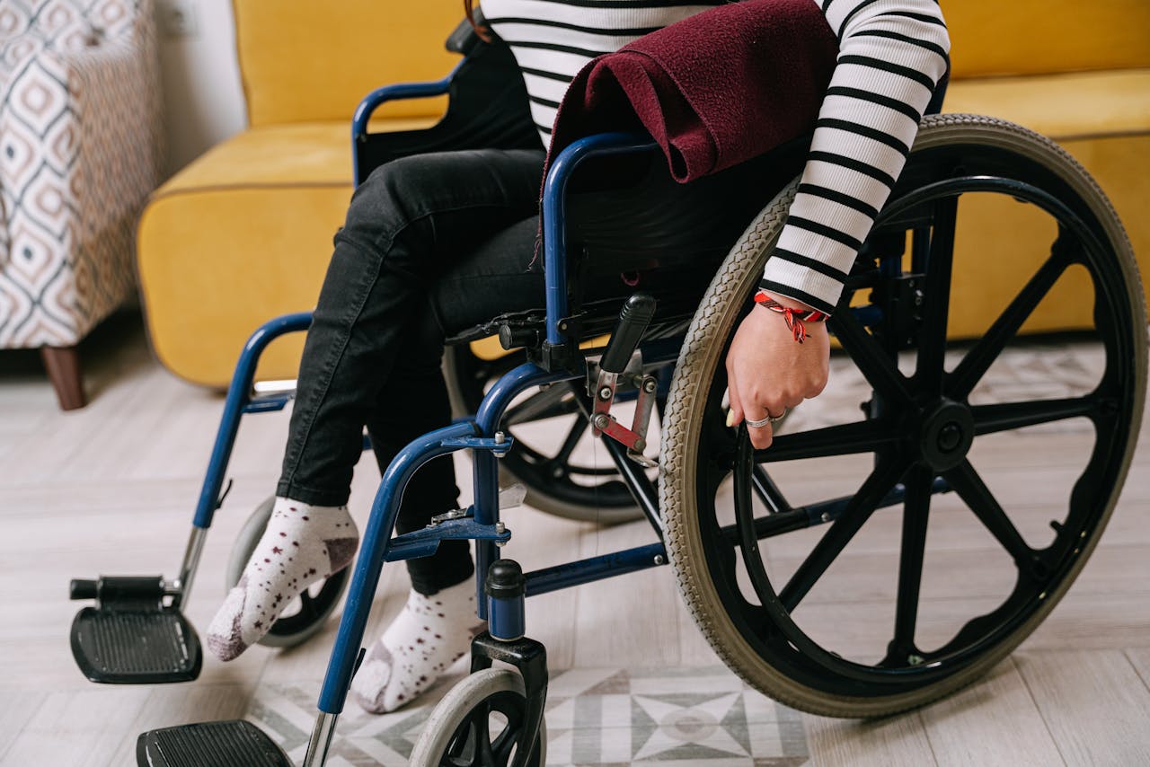 Person in White and Black Striped Long Sleeves Sitting in a Wheelchair